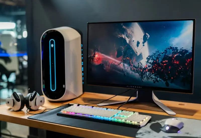 A desktop computer, monitor, keyboard and mouse on a desk.